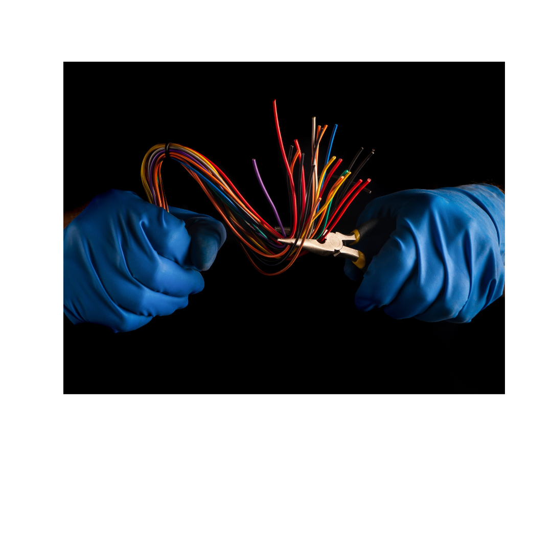Close-up of hands in blue safety gloves working with colorful electrical wires against dark background